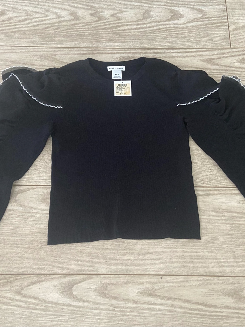 Club Monaco Black Knit women’s Top with White Trim Ruffle Sleeves. Size: XS.